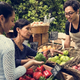 farmer at farmers market selling produce to customers